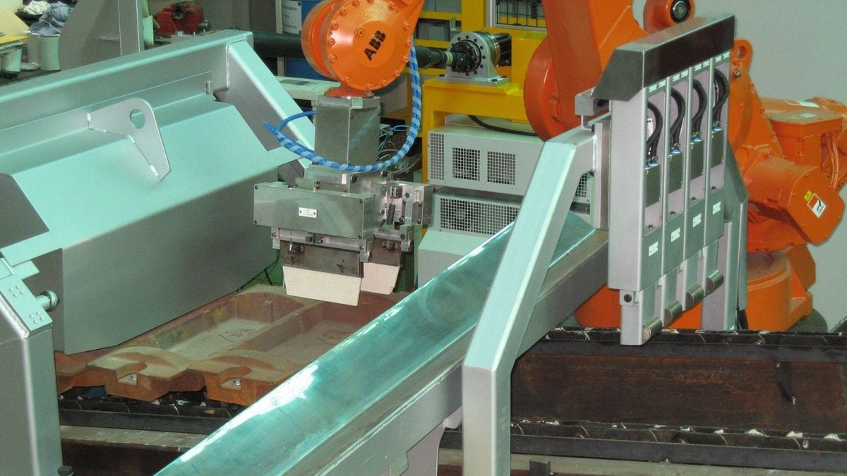 Robotic arms over a conveyor belt